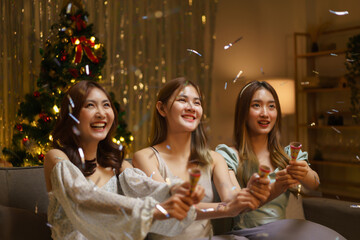New Year celebration concept, Young beautiful group shooting confetti poppers with fun in party