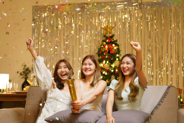 New Year party concept, Young beautiful group shooting confetti firework poppers with fun in party