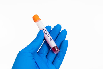 Hand holding blood test tube with word COVID-19