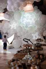 Light photozone on children birthday party. Clouds and Moon balloons