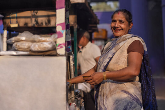 Portrait of a smiling female vendor at her roadside food stall