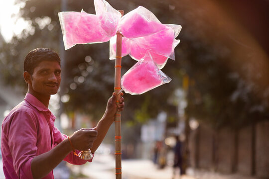 Male vendor selling cotton candy on the street
