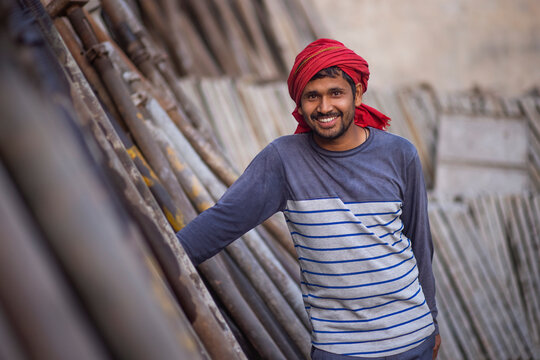 A DAILY WAGE LABOURER STANDING AND LOOKING AT CAMERA