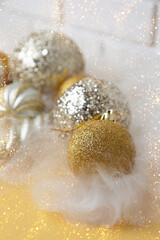 New Year and Christmas background. Christmas balls of golden and white color on a white background. Top view