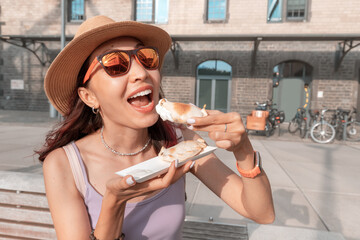 Happy girl has delicious pies with empanadas filling popular in Spain and Argentina. Street food...