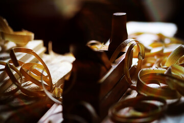 Hand planer with wooden sawdust. On a wooden background. High quality photo