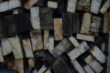 Part of a wood pile with cut needle wood. Wood industry. Brown background
