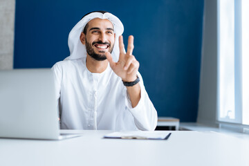 handsome man with dish dasha working in his business office of Dubai. Portraits of a successful...