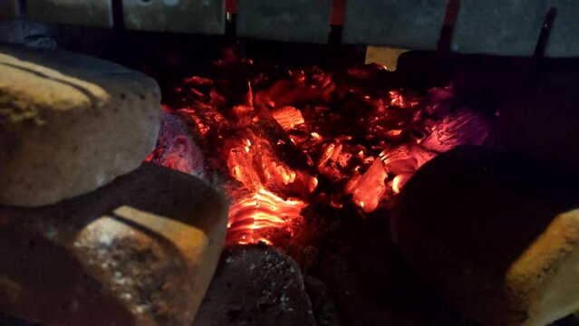 Tilt up shot of Guatemalan tortillas in traditional wooden stove. Black corn tortillas