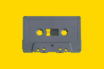 Retro cassette tape isolated on yellow background, top view, copy space, clipping path.