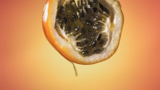 Slow Motion Macro Shot of Flowing Granadilla Juice from Halved Granadilla