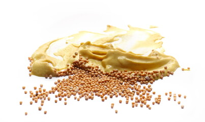 Yellow mustard sauce, spread with mustard grains isolated on white, side view