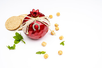 Obraz na płótnie Canvas Gift pomegranate with a horseshoe for good luck and nuts with mint leaves on a white background