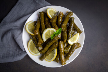 Delicious dolma (sarma) stuffed grape leaves rice, white yogurt sauce. Lebanese dolma sarma on...