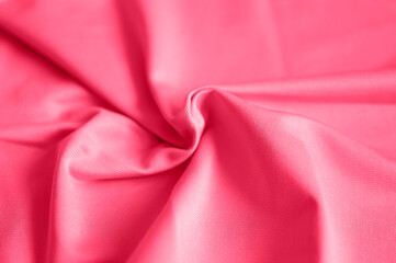 microfiber fabric pink color background with pleats, top view. toned in viva magenta, trend color of the year 2023