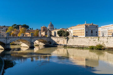 Fototapeta na wymiar view of downtown Rome on the banks of the Tiber River with Saint Peter's Basilica in the background