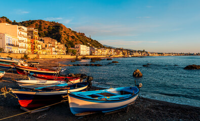 Fototapeta na wymiar boats in a dock in morning sunrise sea gulf with a embankment of a town on a background