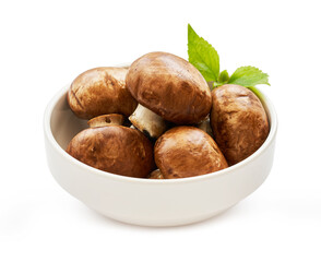 brown champignon button mushroom and green leaf in white bowl isolated on white background. pile of brown champignon button mushroom.                                                          