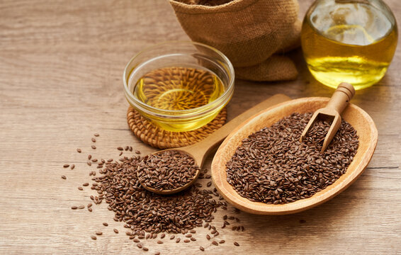 flaxseed linseed and oil in wood bowl on wooden table background. flaxseed linseed oil and bag. flaxseed linseed oil                                                      