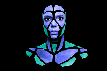 Portrait of a human with creative art makeup posing in the studio. Shape of colored polygons on beautiful face, neck and shoulders. Parts of face isolated on black background.