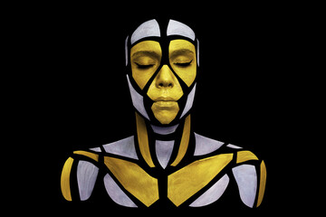 Portrait of a human with creative art makeup posing in the studio. Shape of colored polygons on beautiful face, neck and shoulders. Parts of face isolated on black background.