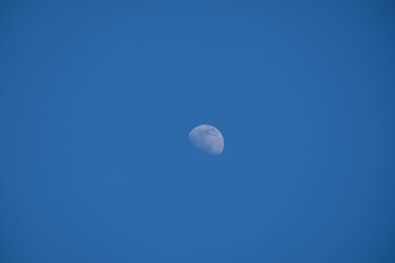 Small moon on a blue background - third quarter