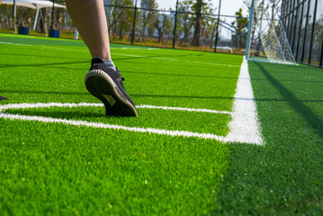 Obraz premium A player takes a corner kick on a brand new soccer field