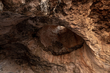 Hole  for air and light in the ceiling of the cave where the primitive people lived in Tel Yodfat National park, in northern Israel
