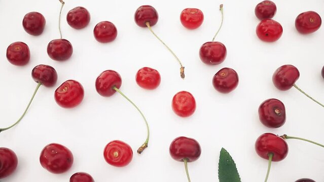 red cherries lie patern on a white background