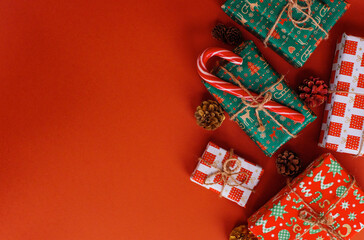 Christmas presents layout on red festive backdrop. Winter holidays concept