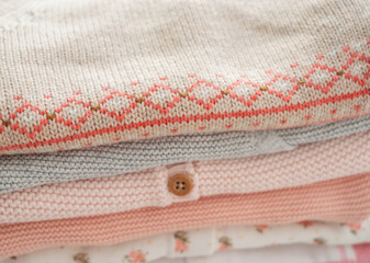 Close-up of knitted things in pastel colors. Knitting, needlework, hobby.