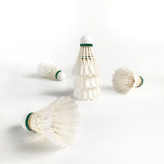 Piled shuttlecocks in the middle of overturned shuttlecocks. Isolated on white background