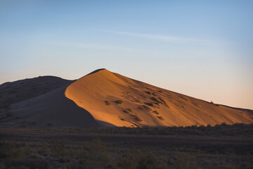 Fototapeta na wymiar Singing dune at sunset in Altyn Emel National Park. Kazakhstan
