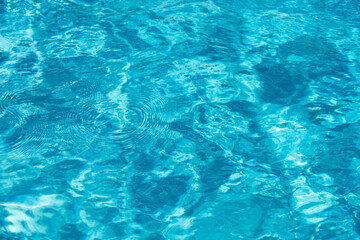 Fototapeta na wymiar Ripped water in swimming pool. Surface of blue swimming pool, background of water.
