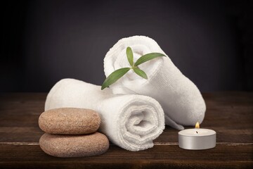Spa concept. Fresh towel and candles on the desk