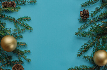 christmas background - pine tree branches and decor on blue copy space