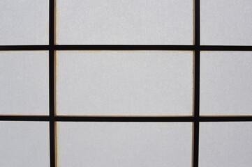 Rectangular and square Japanese shoji paper window frame with partitions with light in Japan