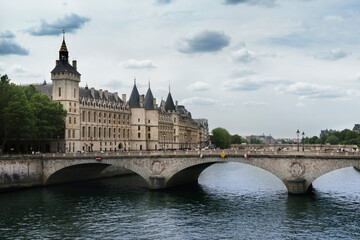 View of the Pont au Change over the Seine River in Paris with La Conciergerie and the Clock Tower in the background.