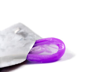 Presrvatif in macro half out of its packaging.