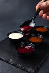 sauces of Asian cuisine on a black background
