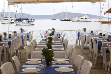 Empty table and chair for dining set nearly sea ocean beach on white cloud blue sky