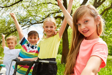 Friends celebrating success together at park in summer