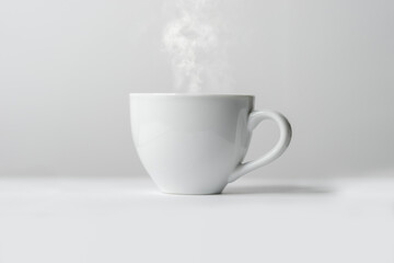 white cup of hot coffee with steam 