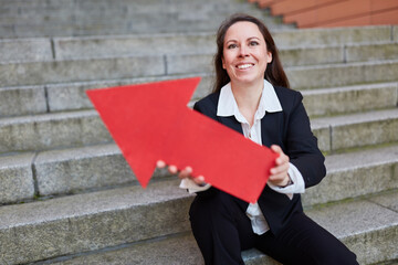 Confident businesswoman holding red arrow symbol as career sign