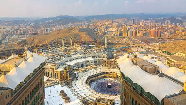 Time lapse wide angle of Muslim pilgrims circling around the holy Kaaba at day and praying inside al Masjid al Haram in Mecca, Saudi Arabia. Prores 4KUHD