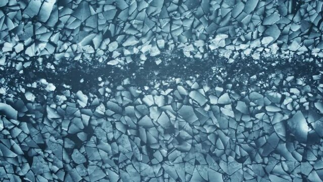 Frozen Lake Surface. The camera slowly moves over the cracked ice surface of the river. 