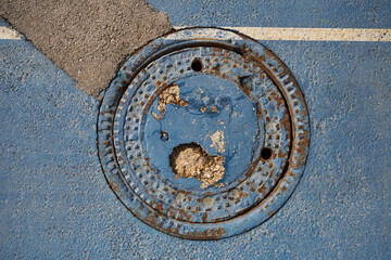 sewer manhole, scuffed coating with irregularities and roughness
