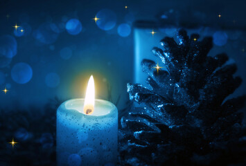 Blue Advent candle and decoration isolated on blur background.