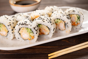 Roll sushi with royal prawn, avocado, cream cheese, sesame. Sushi menu. Japanese food.