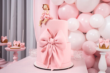 Pink birthday cake for a little girl with a sugar doll. Pink style birthday party